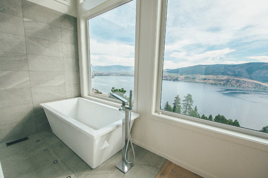 Inspiration for a mid-sized modern master gray tile and porcelain tile porcelain tile and gray floor freestanding bathtub remodel in Vancouver with multicolored walls