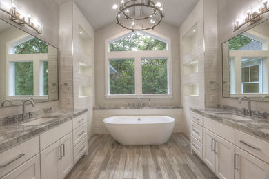 Example of a large transitional master white tile and ceramic tile ceramic tile and beige floor bathroom design in Houston with shaker cabinets, white cabinets, a two-piece toilet, beige walls, an undermount sink, quartz countertops and a hinged shower door
