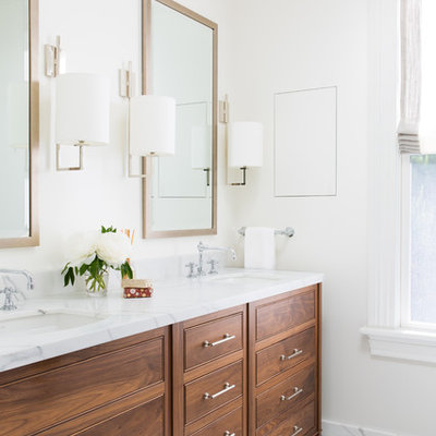 Inspiration for a timeless white floor bathroom remodel in San Francisco with beaded inset cabinets, medium tone wood cabinets, white walls, an undermount sink and white countertops