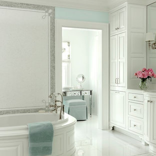 Inspiration for a coastal white tile white floor drop-in bathtub remodel in St Louis with raised-panel cabinets and white cabinets