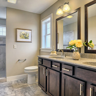Bathroom - large craftsman master beige tile ceramic tile and multicolored floor bathroom idea in Other with raised-panel cabinets, dark wood cabinets, granite countertops, a two-piece toilet, beige walls and an integrated sink