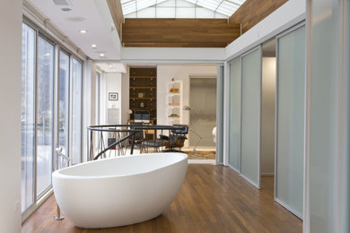 Inspiration for a large contemporary master medium tone wood floor and brown floor freestanding bathtub remodel in Chicago