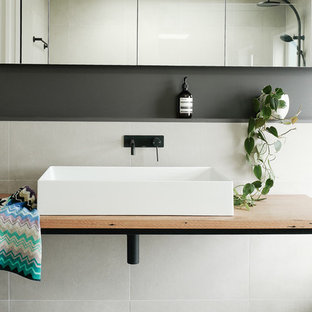 Design ideas for a contemporary bathroom in Canberra - Queanbeyan with white tile, white walls, a vessel sink, wood benchtops, white floor and brown benchtops.