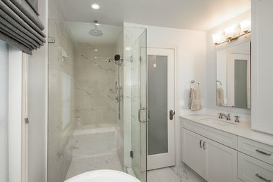 Example of a mid-sized classic master white tile and marble tile marble floor and white floor bathroom design in Dallas with recessed-panel cabinets, gray cabinets, a two-piece toilet, white walls, an undermount sink, quartz countertops, a hinged shower door and white countertops