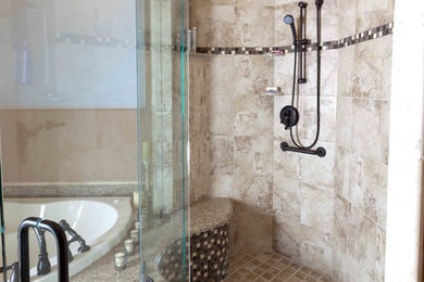 Inspiration for a timeless beige tile and stone tile mosaic tile floor bathroom remodel in Seattle with beige walls