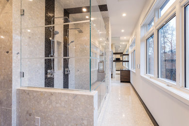 Double shower - mid-sized contemporary master beige tile, black tile and stone tile pebble tile floor double shower idea in New York with beige walls