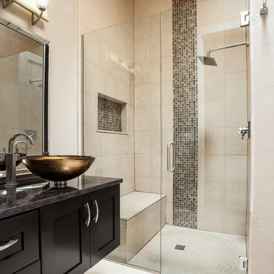 Example of a trendy beige tile bathroom design in Austin with a vessel sink, shaker cabinets, black cabinets, beige walls and a niche