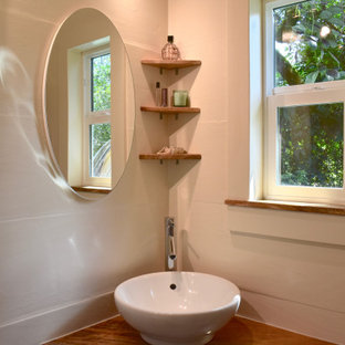 Small beach style 3/4 beige tile and ceramic tile bamboo floor, beige floor, single-sink and exposed beam bathroom photo in Hawaii with open cabinets, beige cabinets, a one-piece toilet, beige walls, a vessel sink, wood countertops, beige countertops, a niche and a floating vanity