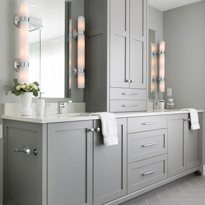 Bathroom - large transitional master porcelain tile, gray floor and double-sink bathroom idea in Minneapolis with shaker cabinets, gray cabinets, a one-piece toilet, gray walls, an undermount sink, solid surface countertops, a hinged shower door, white countertops and a built-in vanity