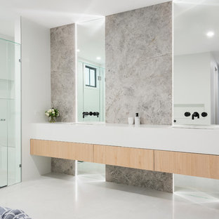 Inspiration for an expansive contemporary master bathroom in Brisbane with light wood cabinets, a freestanding tub, a shower/bathtub combo, gray tile, marble, white walls, marble floors, an undermount sink, engineered quartz benchtops, white floor, white benchtops, flat-panel cabinets and a hinged shower door.