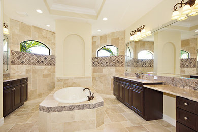 Example of a tuscan multicolored tile and stone tile travertine floor bathroom design in Miami with an undermount sink, raised-panel cabinets, dark wood cabinets and granite countertops