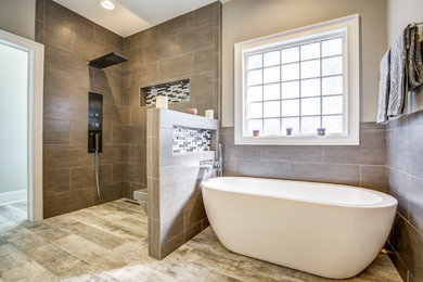 Mid-sized trendy master gray tile and porcelain tile ceramic tile bathroom photo in Wilmington with flat-panel cabinets, white cabinets, a two-piece toilet, gray walls, a vessel sink and quartzite countertops