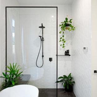 Design ideas for a mid-sized contemporary bathroom in Melbourne with a freestanding tub, ceramic floors, an open shower, a curbless shower, white tile, white walls and grey floor.