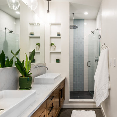 Alcove shower - mid-sized contemporary 3/4 white tile and ceramic tile concrete floor and gray floor alcove shower idea in Seattle with shaker cabinets, white walls, a vessel sink, quartz countertops, a hinged shower door, white countertops and dark wood cabinets