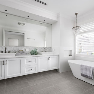 Design ideas for a large transitional bathroom in Perth with shaker cabinets, white cabinets, a freestanding tub, white walls, cement tiles, a vessel sink, grey floor, white benchtops and gray tile.
