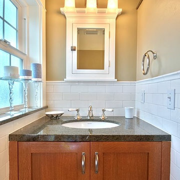 Three light bathroom vanity, beige walls and lots of natural light