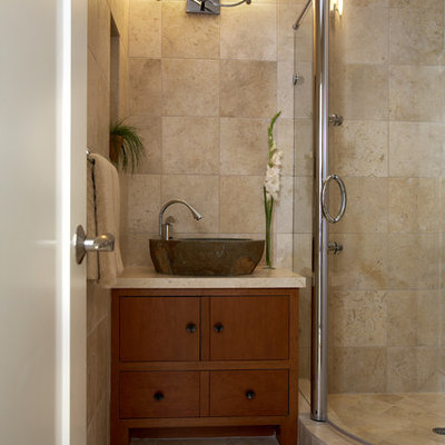 Example of a mid-sized zen 3/4 travertine tile travertine floor corner shower design in San Francisco with a vessel sink, flat-panel cabinets, medium tone wood cabinets, granite countertops and beige walls