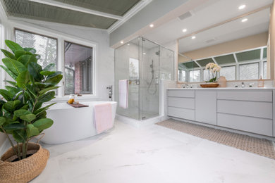 Inspiration for a large contemporary master gray tile and marble tile marble floor and gray floor bathroom remodel in Ottawa with flat-panel cabinets, gray cabinets, beige walls, an undermount sink, a hinged shower door, a one-piece toilet, quartzite countertops and white countertops