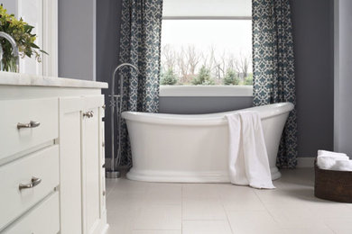 Example of a large transitional master vinyl floor freestanding bathtub design in Other with flat-panel cabinets, white cabinets, gray walls and marble countertops