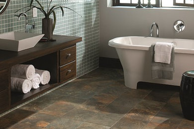 Example of a mid-sized transitional master green tile and ceramic tile porcelain tile freestanding bathtub design in Seattle with raised-panel cabinets, medium tone wood cabinets, a one-piece toilet, white walls, a vessel sink and wood countertops