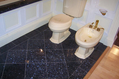 Example of a master black tile bathroom design in Portland Maine with a one-piece toilet