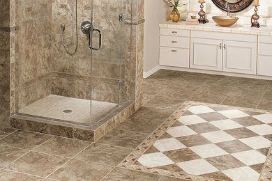 Corner shower - mid-sized traditional master beige tile and porcelain tile beige floor corner shower idea in Other with recessed-panel cabinets, beige cabinets, beige walls, a vessel sink, tile countertops and a hinged shower door