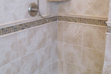 Inspiration for a large beige tile corner shower remodel in New York