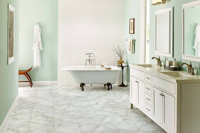 Medium sized classic ensuite bathroom in Boston with shaker cabinets, white cabinets, a claw-foot bath, white tiles, metro tiles, green walls, marble flooring, a submerged sink, solid surface worktops and white floors.