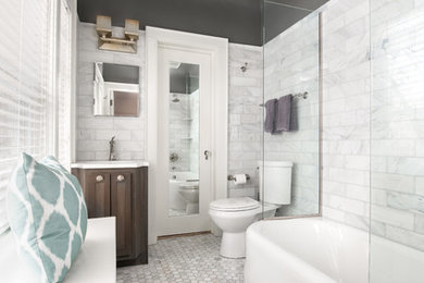Mid-sized elegant master white tile and marble tile marble floor and white floor bathroom photo in Milwaukee with furniture-like cabinets, medium tone wood cabinets, a two-piece toilet, gray walls, an undermount sink, quartzite countertops and white countertops