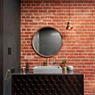 This is an example of an industrial bathroom in Adelaide with furniture-like cabinets, brown cabinets and a vessel sink.