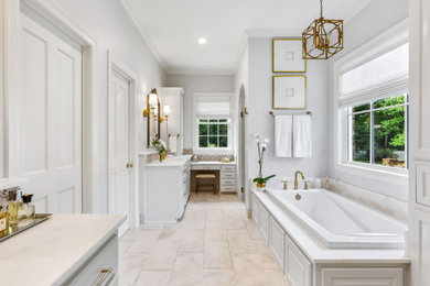 На фото: ванная комната в классическом стиле с белыми фасадами, накладной ванной, серыми стенами, врезной раковиной, серым полом, белой столешницей, тумбой под две раковины и встроенной тумбой с