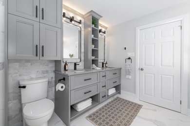 Inspiration for a mid-sized cottage master gray tile and marble tile marble floor, gray floor and double-sink bathroom remodel in Ottawa with recessed-panel cabinets, gray cabinets, quartz countertops, gray countertops, a two-piece toilet, gray walls and an undermount sink