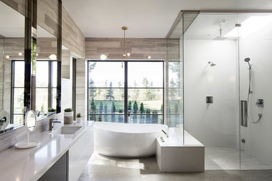 This is an example of a contemporary ensuite bathroom in Salt Lake City with flat-panel cabinets, white cabinets, a freestanding bath, a double shower, a submerged sink and a hinged door.