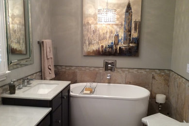 Example of a mid-sized transitional master beige tile and ceramic tile ceramic tile bathroom design in Birmingham with an undermount sink, flat-panel cabinets, dark wood cabinets, marble countertops, a two-piece toilet and beige walls