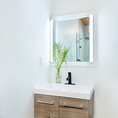 Inspiration for a mid-sized rustic 3/4 white tile and subway tile concrete floor and gray floor walk-in shower remodel in Other with open cabinets, a two-piece toilet, white walls, an integrated sink, solid surface countertops, a hinged shower door and white countertops
