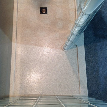 Top down view of glass block shower with custom matte finish solid surface pan