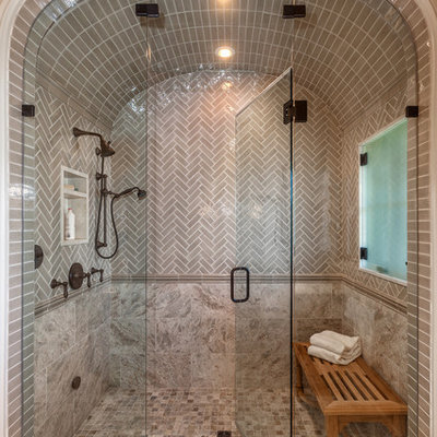 Example of a large tuscan master multicolored tile and ceramic tile ceramic tile and multicolored floor bathroom design in Other with a hinged shower door and a one-piece toilet