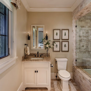 Diseño de cuarto de baño mediterráneo, de tamaño medio, con ducha doble, baldosas y/o azulejos beige, paredes beige, lavabo sobreencimera, encimera de granito, bañera esquinera, sanitario de una pieza, suelo de baldosas de cerámica, suelo multicolor, ducha con puerta con bisagras, armarios estilo shaker y puertas de armario blancas
