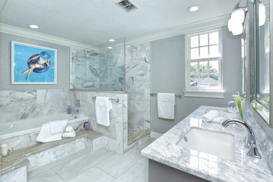 Bathroom - mid-sized traditional master gray tile and marble tile porcelain tile and gray floor bathroom idea in Jacksonville with shaker cabinets, gray cabinets, gray walls, an undermount sink, marble countertops, a hinged shower door and gray countertops