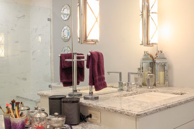 Example of a mid-sized trendy kids' corner shower design in New York with flat-panel cabinets, white cabinets, a two-piece toilet, gray walls, an undermount sink and quartz countertops