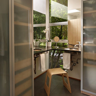 Photo of a modern bathroom in Seattle with an undermount sink and glass-front cabinets.