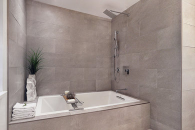 Example of a trendy gray tile and porcelain tile bathroom design in Vancouver with flat-panel cabinets, white cabinets, quartz countertops and a two-piece toilet