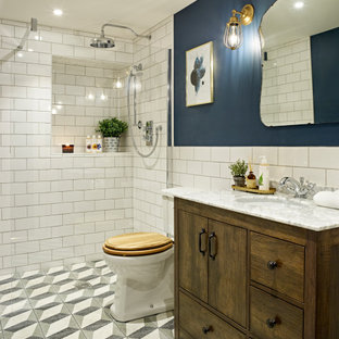 Inspiration for a traditional bathroom in Kent with flat-panel cabinets, dark wood cabinets, a built-in shower, white tiles, blue walls, cement flooring, a submerged sink, multi-coloured floors, an open shower and white worktops.