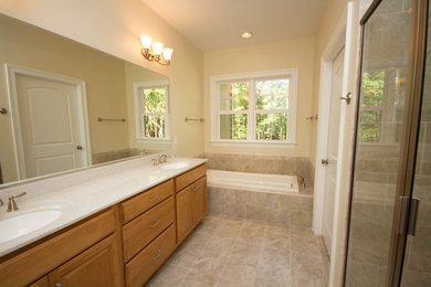 Bathroom - mid-sized traditional 3/4 ceramic tile and beige tile ceramic tile bathroom idea in Richmond with raised-panel cabinets, light wood cabinets, yellow walls, an undermount sink, quartz countertops and a two-piece toilet