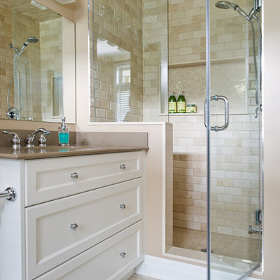 Alcove shower - traditional beige tile alcove shower idea in Toronto with an undermount sink, white cabinets and a niche
