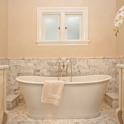 Example of a small classic master mosaic tile and white tile mosaic tile floor freestanding bathtub design in Portland with white cabinets, marble countertops, an undermount sink and beige walls