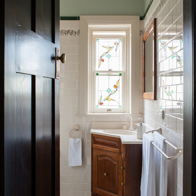 Elegant white tile and ceramic tile ceramic tile bathroom photo in Sydney with an integrated sink, raised-panel cabinets, dark wood cabinets and green walls