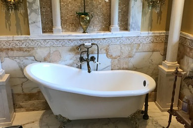 Claw-foot bathtub - mid-sized traditional master white tile and marble tile marble floor and white floor claw-foot bathtub idea in Philadelphia with raised-panel cabinets, beige cabinets, yellow walls, an undermount sink and marble countertops