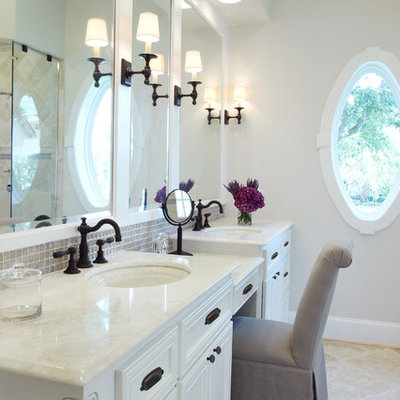Elegant beige tile and mosaic tile bathroom photo in Houston with an undermount sink, white cabinets and white countertops