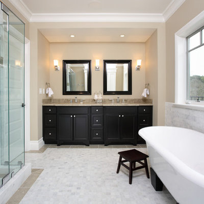 Example of a classic freestanding bathtub design in San Francisco with black cabinets